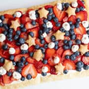 Overhead view of a patriotic Berries and Stars dessert with star-shaped puff pastry and fresh strawberries and blueberries.