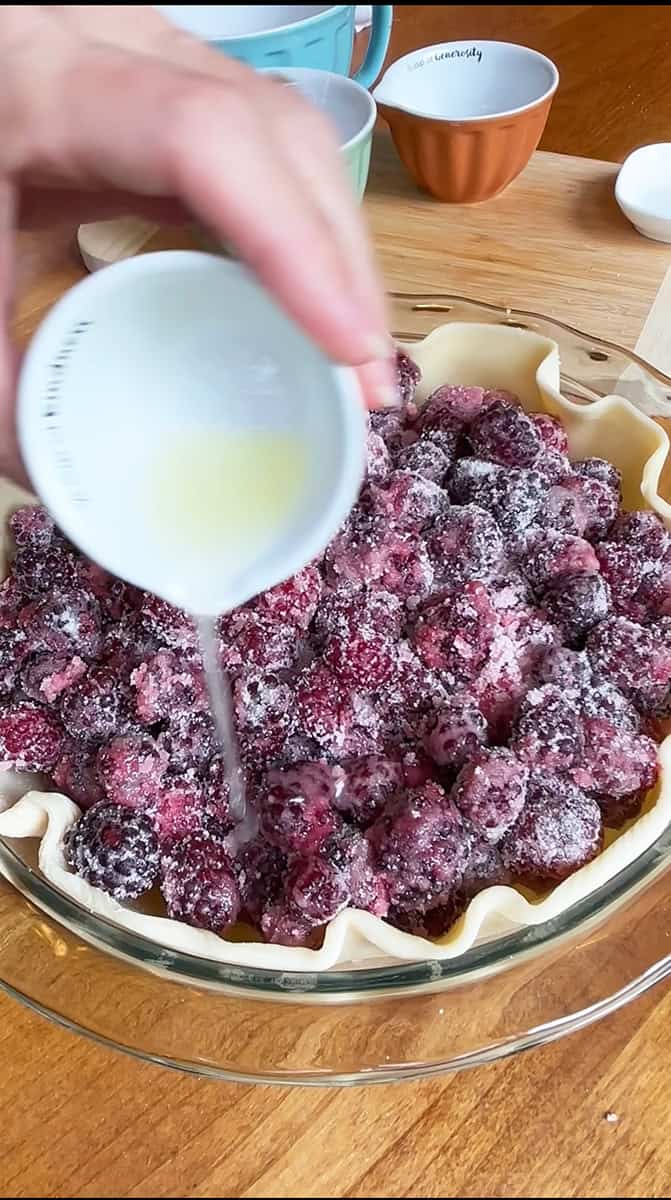Blackberry Pie Step 3 Add lemon juice to berries in the pie crust adn then dot with butter