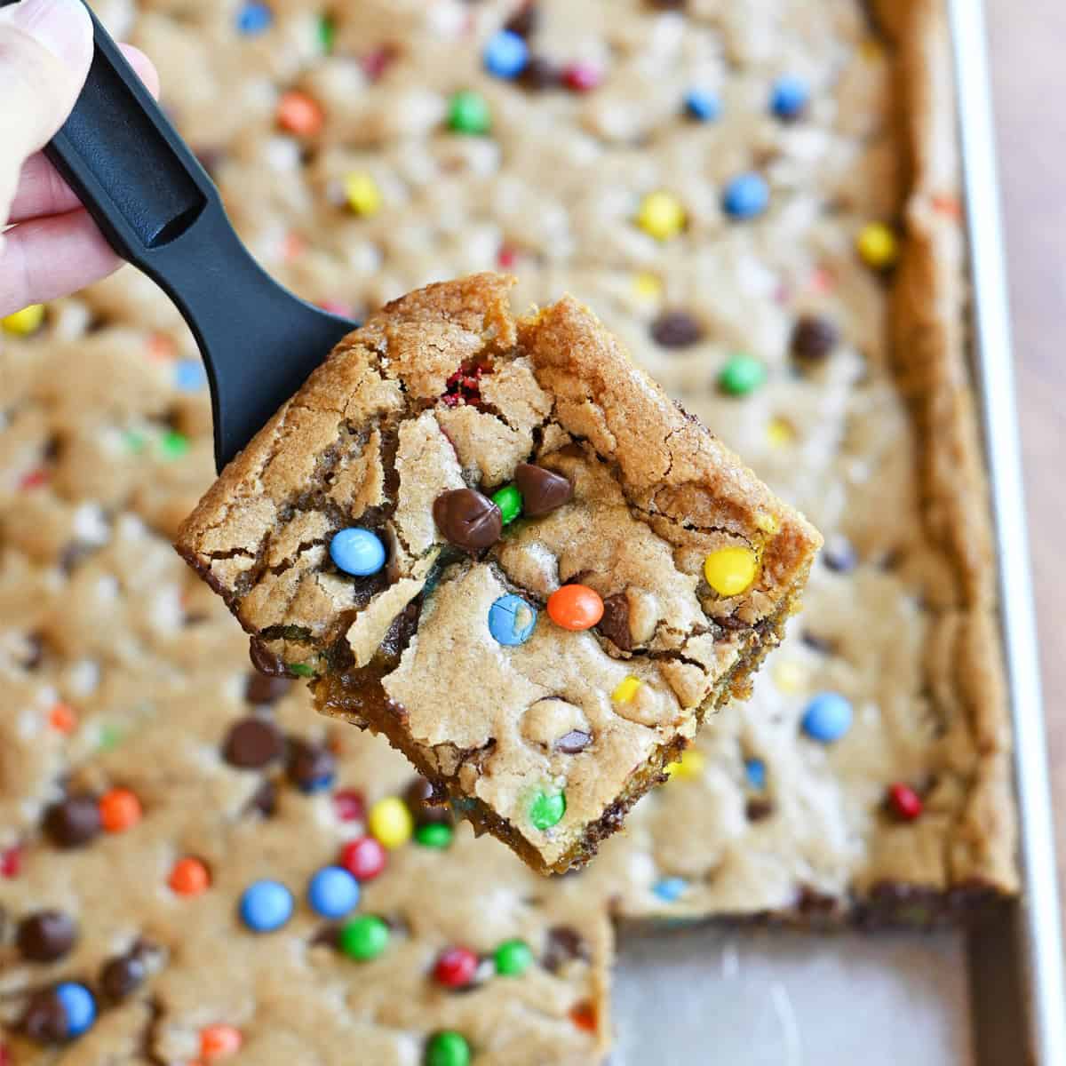 M&M cookie bar slice on server with full pan in background overhead view