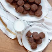 Overhead view of mini gingerbread muffins on a white platter and side plate