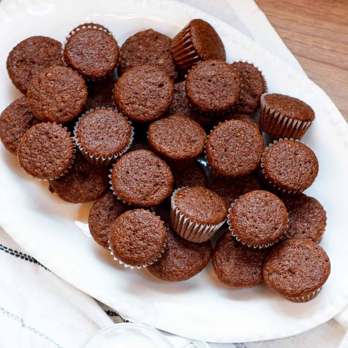 Close-up of mini gingerbread muffins arranged on a white platter