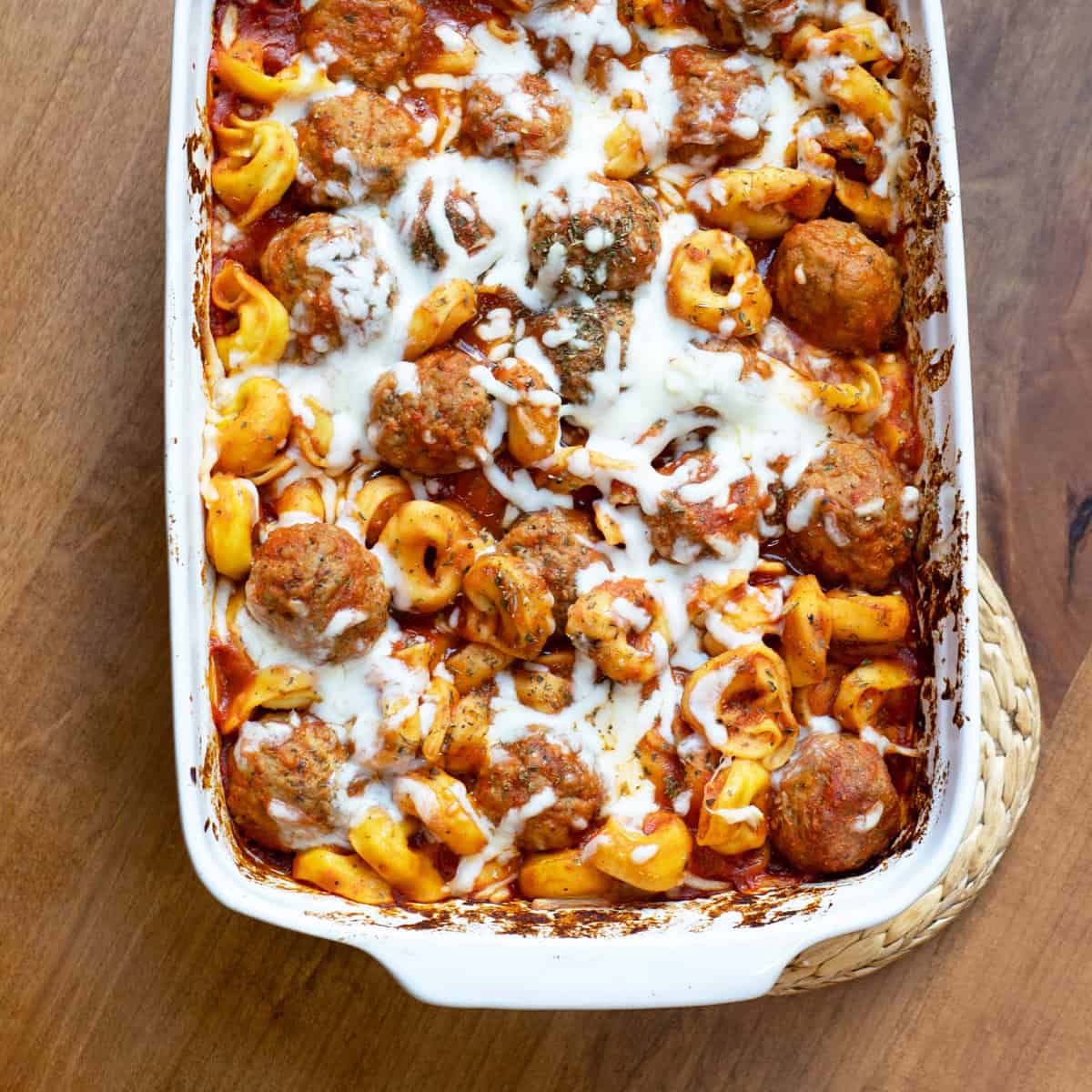 Tortellini Meatball Bake in a serving dish with a spoon ready to serve.