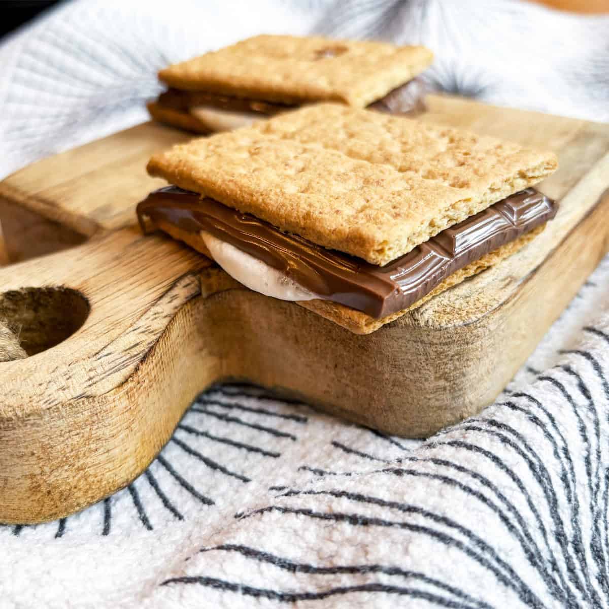 Stack of air fryer s’mores on a board, ready to serve and enjoy.