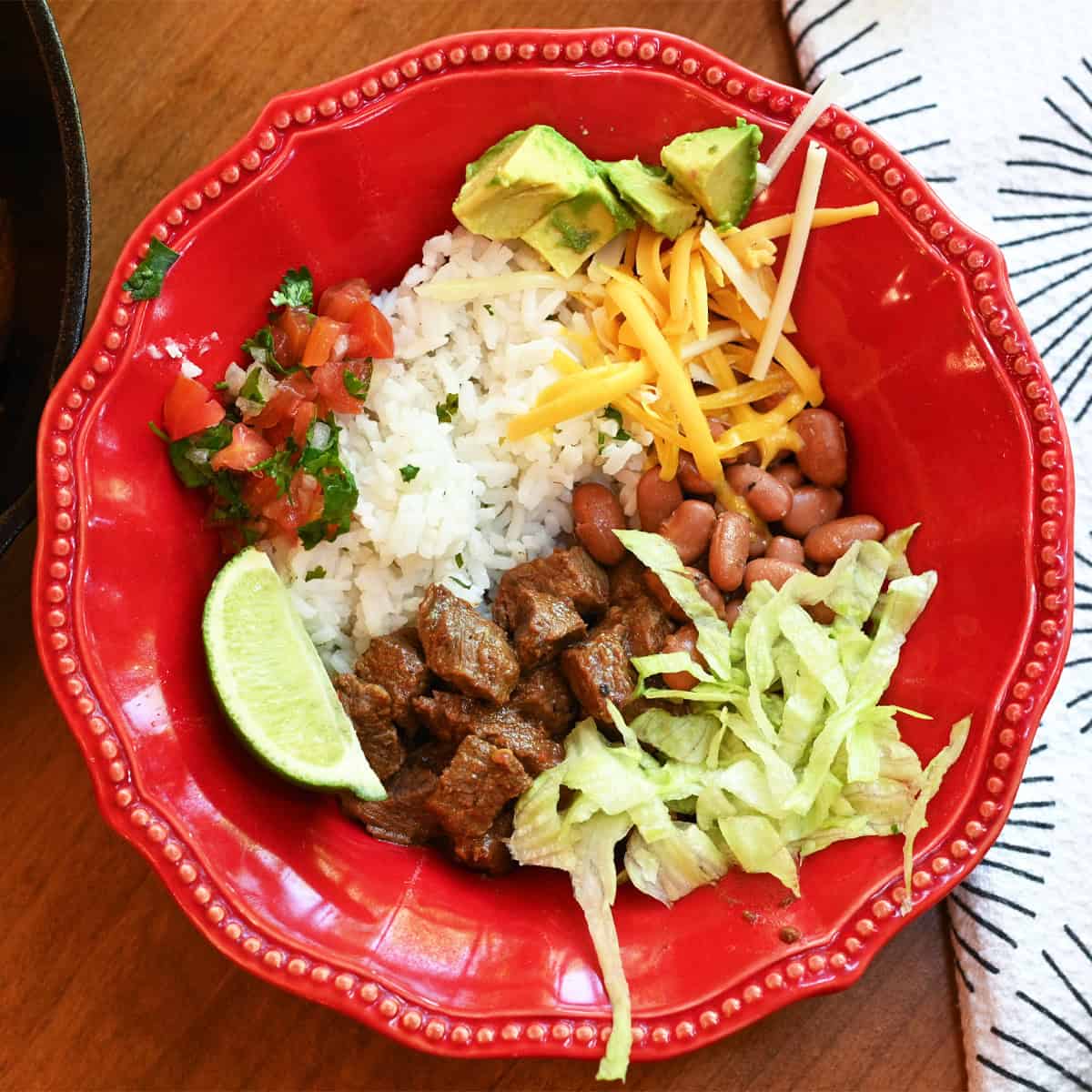 Close-up of a Chipotle Pepper Steak and Rice Bowl with tender steak slices, fluffy rice, and colorful toppings.