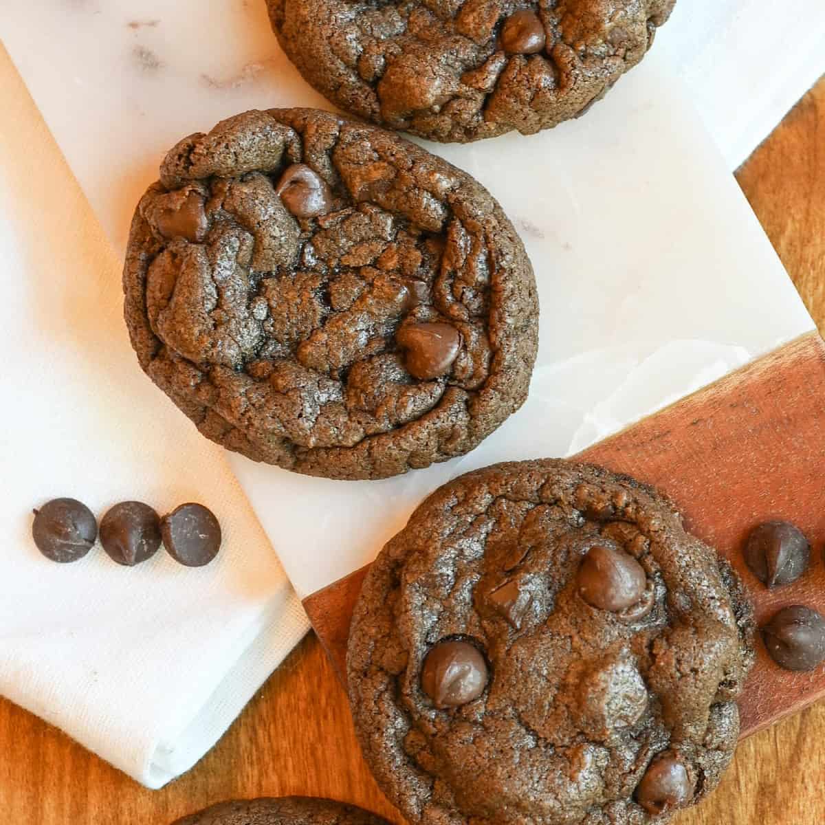 Close-up of a gooey chocolate chocolate chip cookie showing melty chips and soft texture