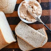 Sliced bread on a wooden cutting board styled in a warm, inviting kitchen setting