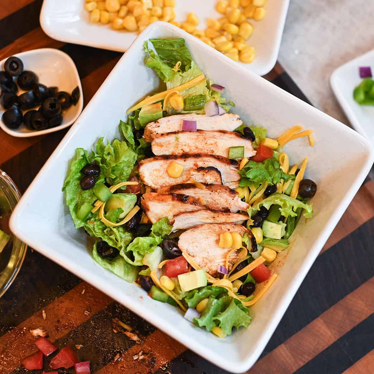 Juicy grilled chicken breasts with Tex-Mex seasoning sliced into a salad