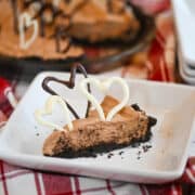 Oreo crumb crust filled with creamy Hershey Bar pie, served a white dish.