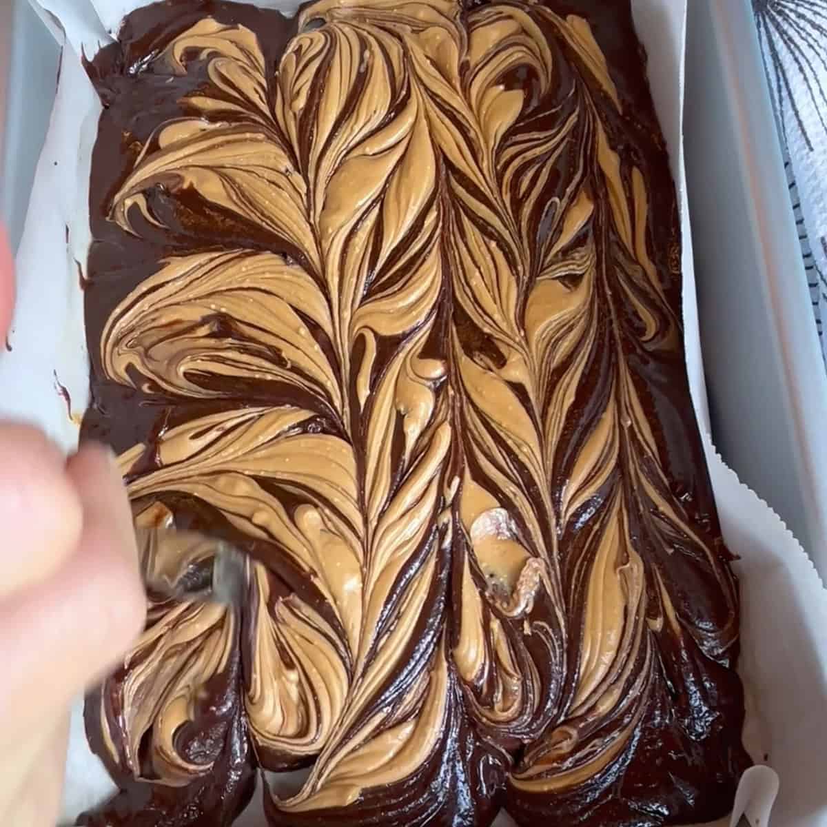 swirling peanut butter mixture all through brownie batter