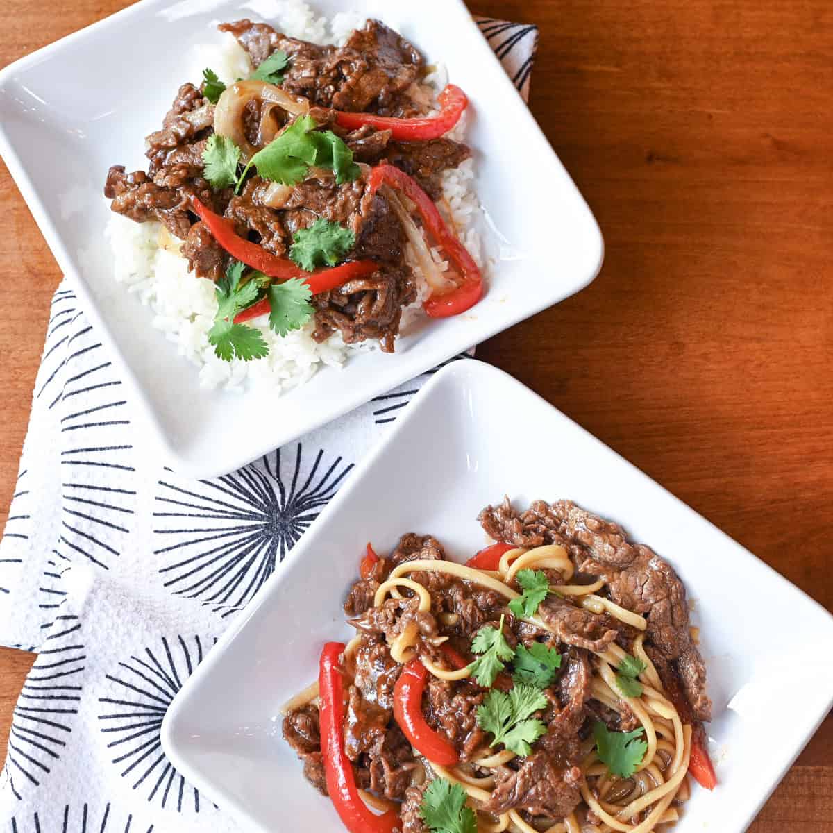 Cooking beef and bell peppers in a wok for stir fry