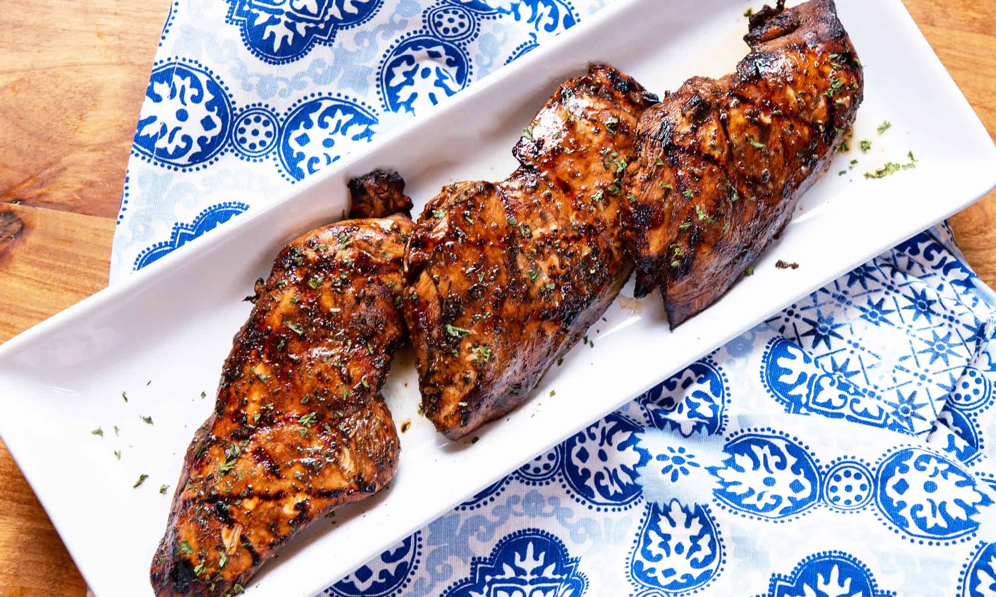 Image of three marinated chicken breasts in round up size