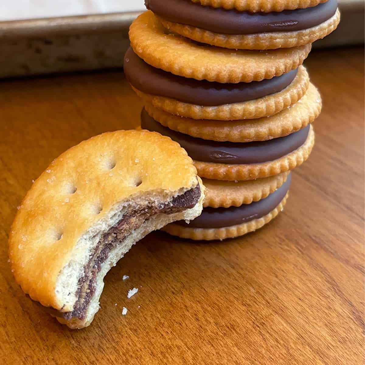 Stack of Ritz Peanut Butter Cup Treats made with Reese’s Thins, showing the salty-sweet layers of chocolate, peanut butter, and crackers.