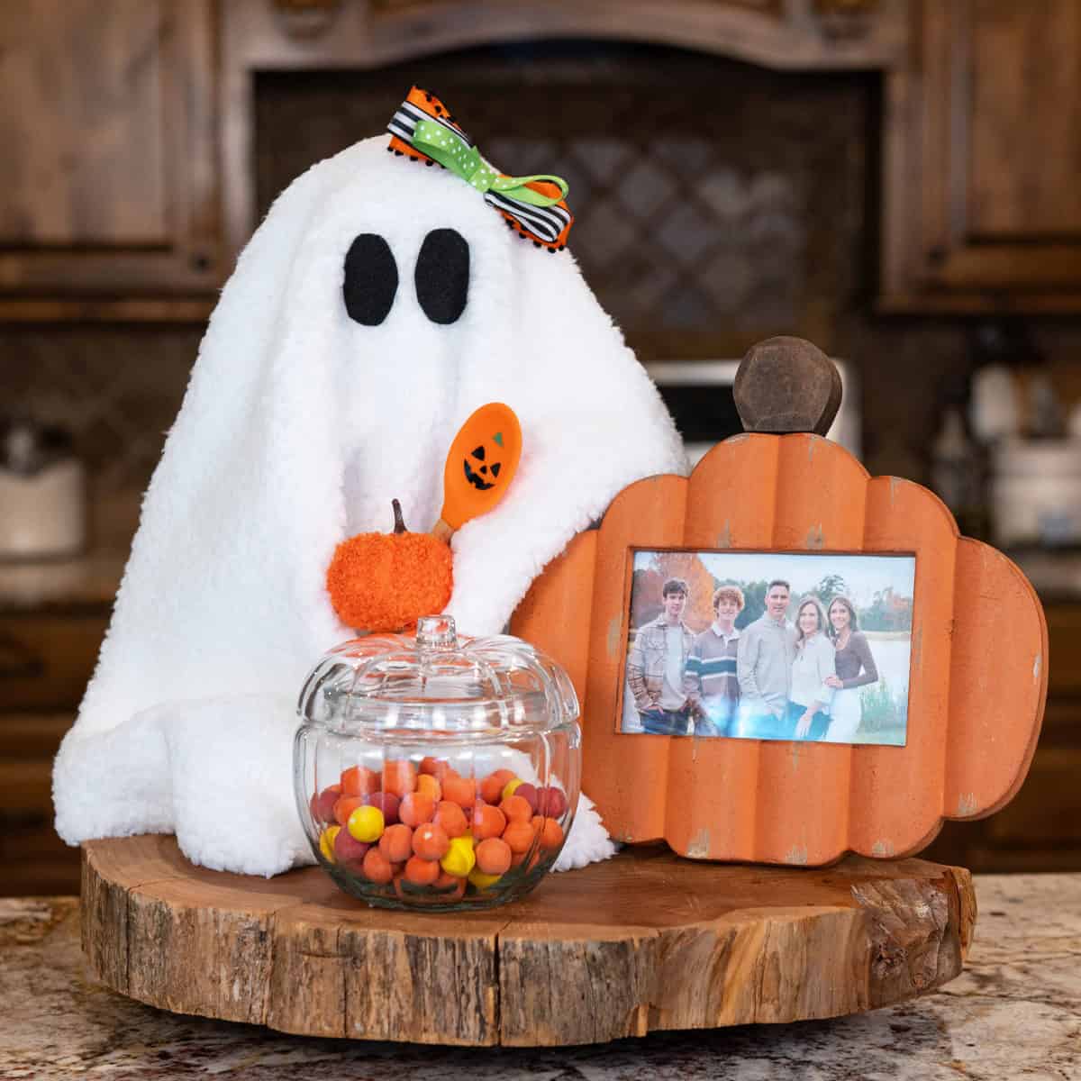 Sherpa Halloween ghost decoration with fuzzy pumpkin and Halloween spatula on kitchen counter