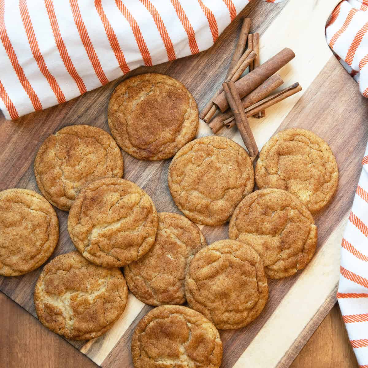 Overhead image of freshly baked pumpkin snickerdoodle cookies arranged on a serving board