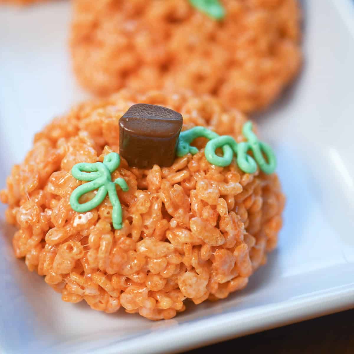 Close-up of a single Rice Krispie Treat pumpkin with candy stem and green vine