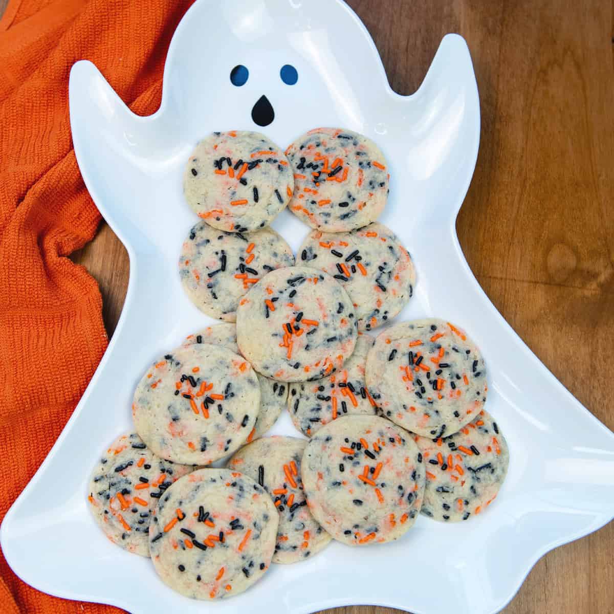 Halloween Funfetti Cookies arranged on a ghost-shaped serving platter with festive colors.
