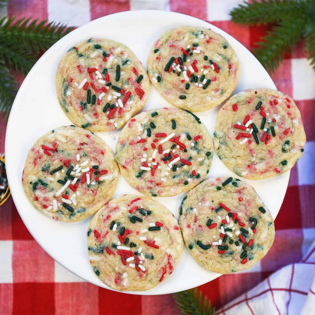 Overhead view of Christmas Funfetti cookies on a white serving platter