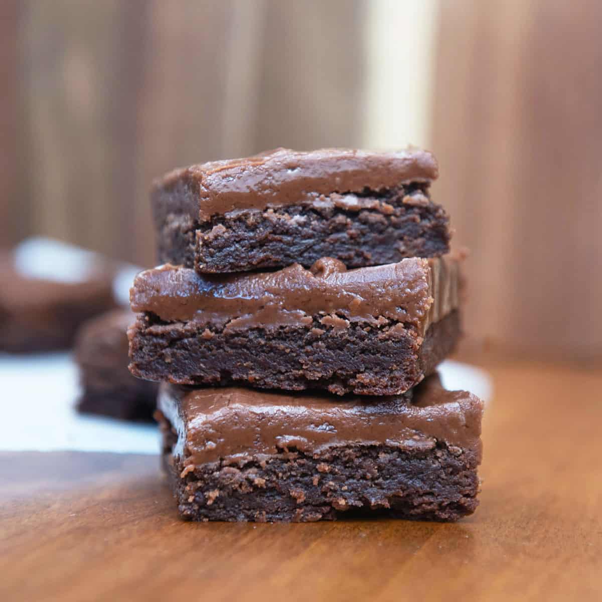 Close-up of fudgy brownies topped with thick chocolate icing