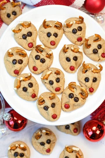Peanut Butter reindeer Cookies close up on white plate with ornaments