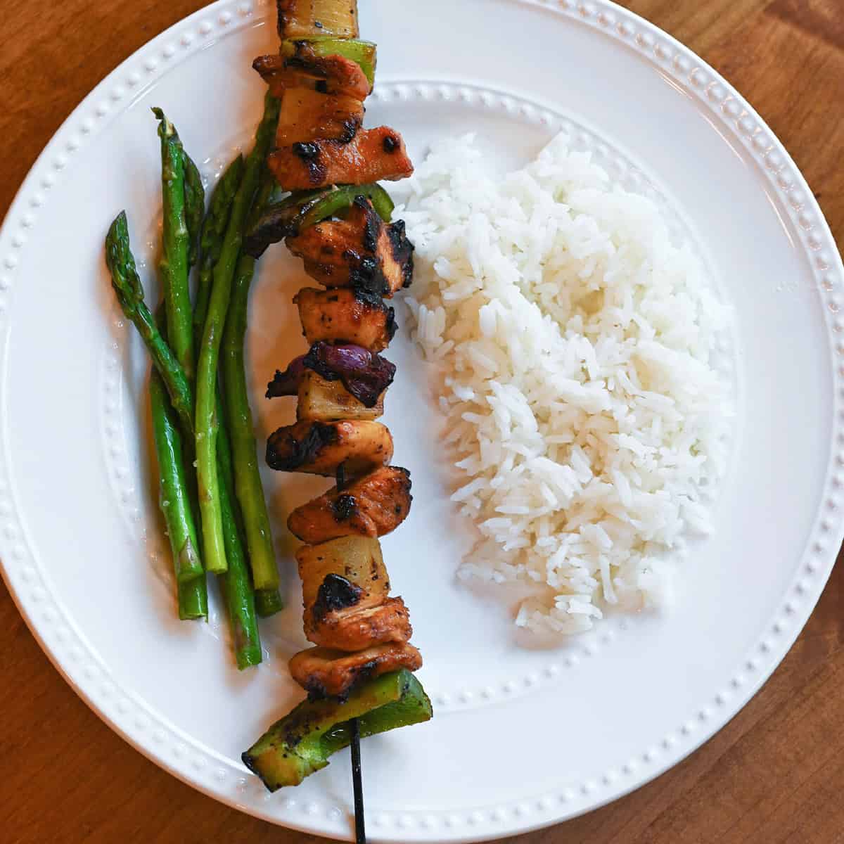 Grilled Hawaiian chicken kabobs with pineapple,  bell peppers, and onions on skewers