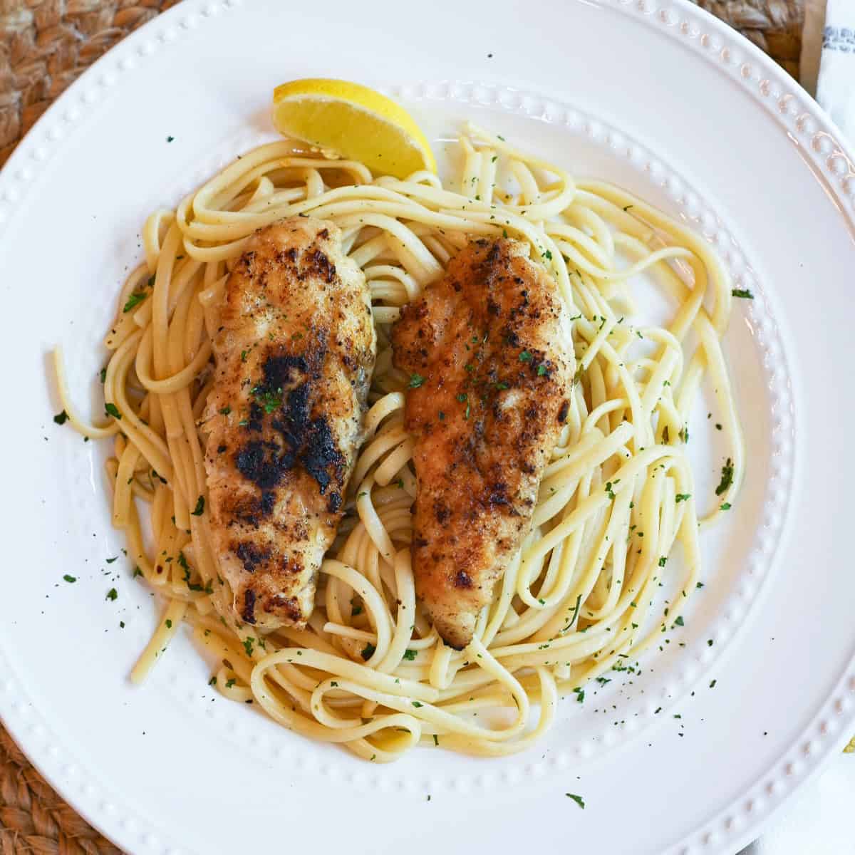 Chicken Scampi served simply on a white plate, highlighting the vibrant colors and textures.