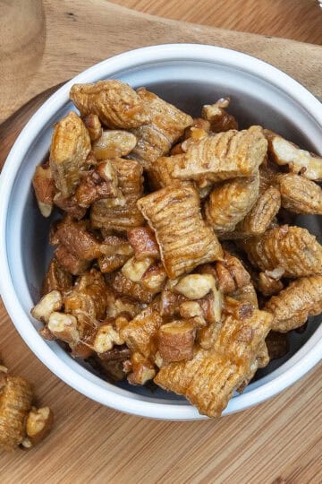 Extreme close-up overhead of pecan praline crunch with glossy praline coating.