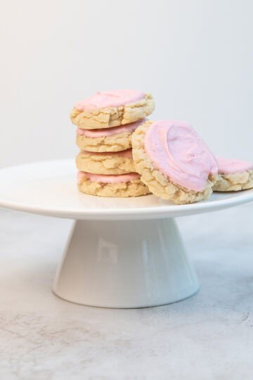 Stack of frosted Swig sugar cookies on a white serving platter.