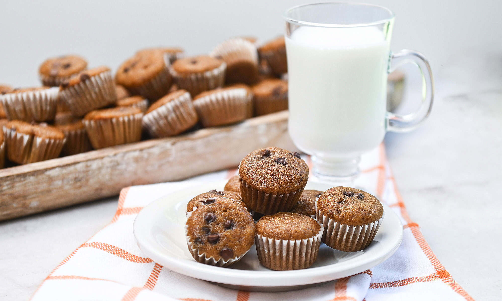A stack of pumpkin muffins on a white plate