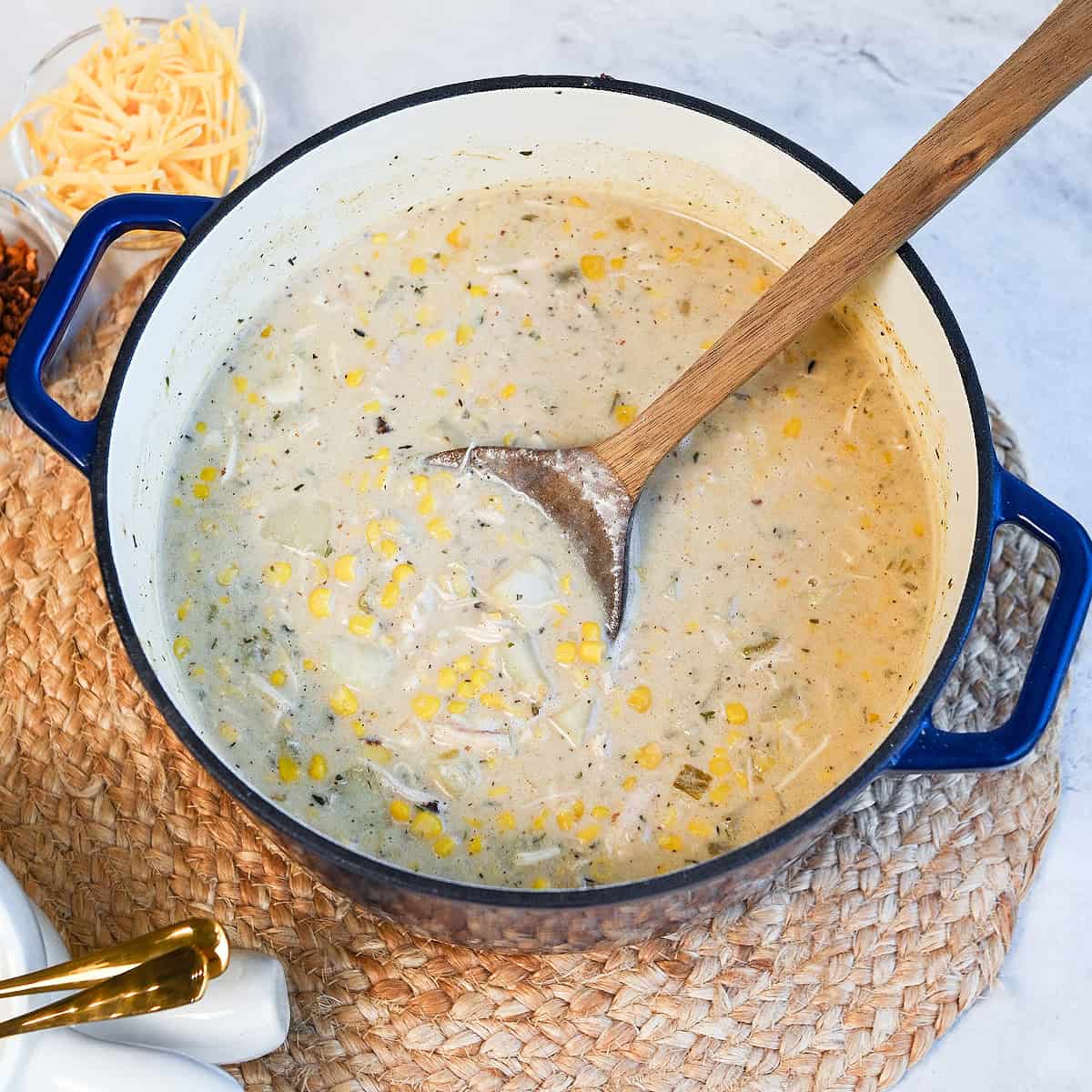 Large pot filled with creamy chicken corn chowder loaded with potatoes, corn, and chicken.