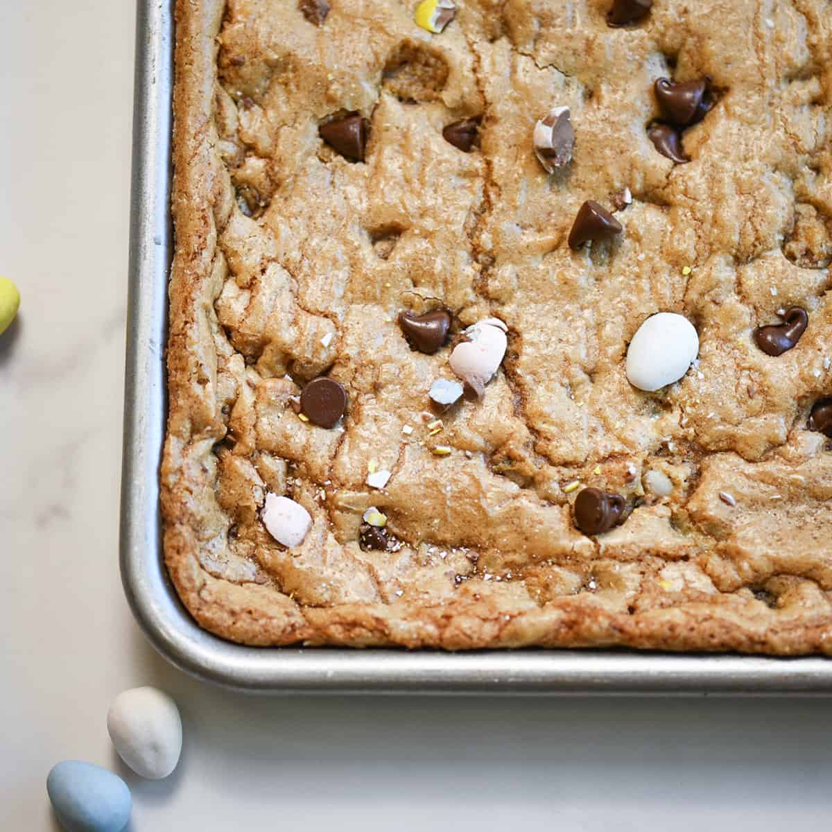 Close-up of corner piece of Cadbury Egg cookie bar showing crisp edges and soft center.