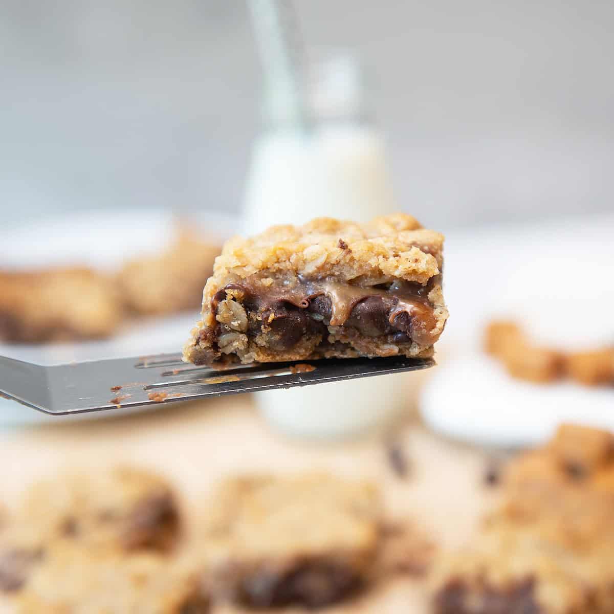 Close-up of Carmelitas bar showing gooey caramel and melted chocolate inside oatmeal layers.