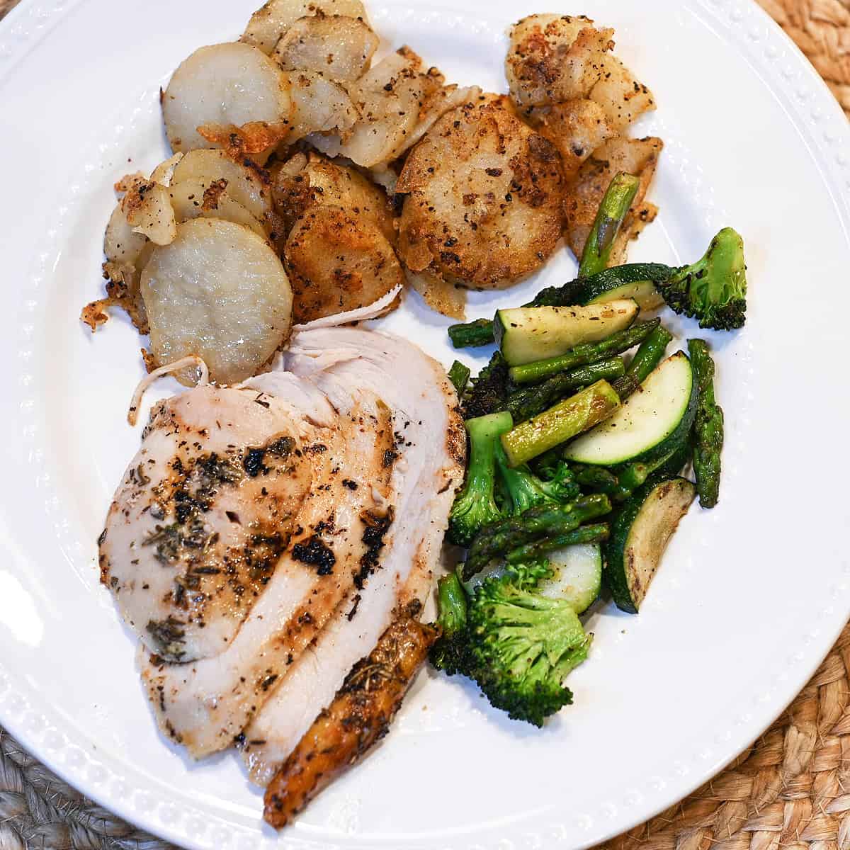 Roasted chicken served on a plate with crispy skin and juicy sliced meat.