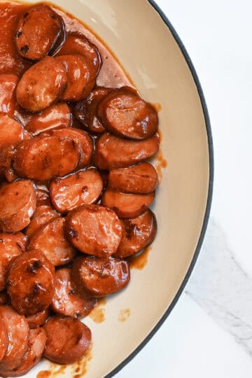 BBQ Sausages in cream skillet ready to serve with no toothpicks
