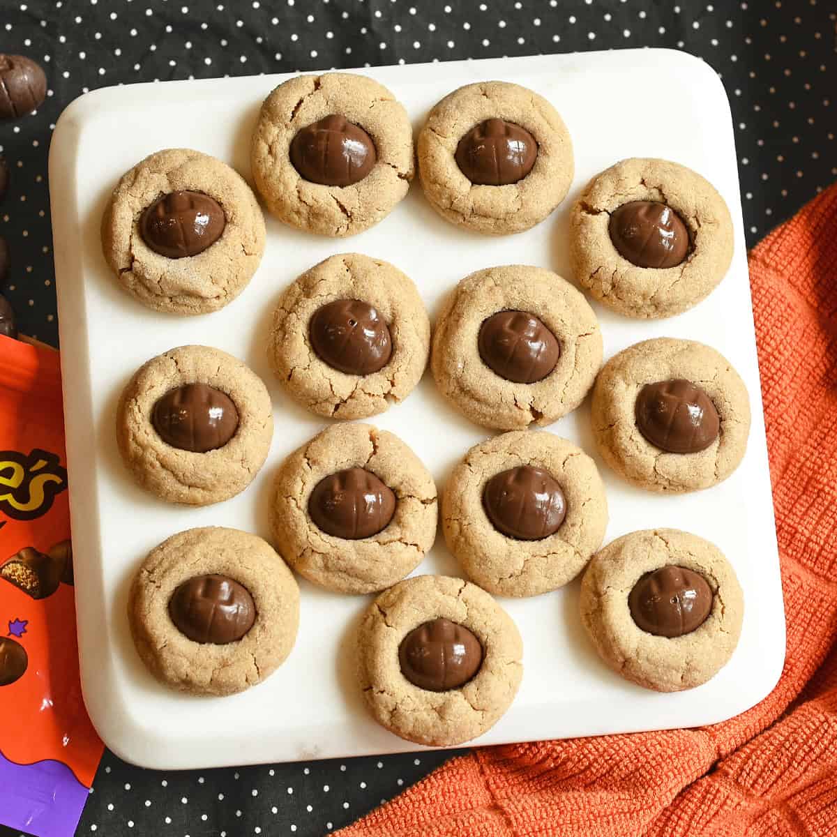 Mini Reeses Pumpkins on white serving board