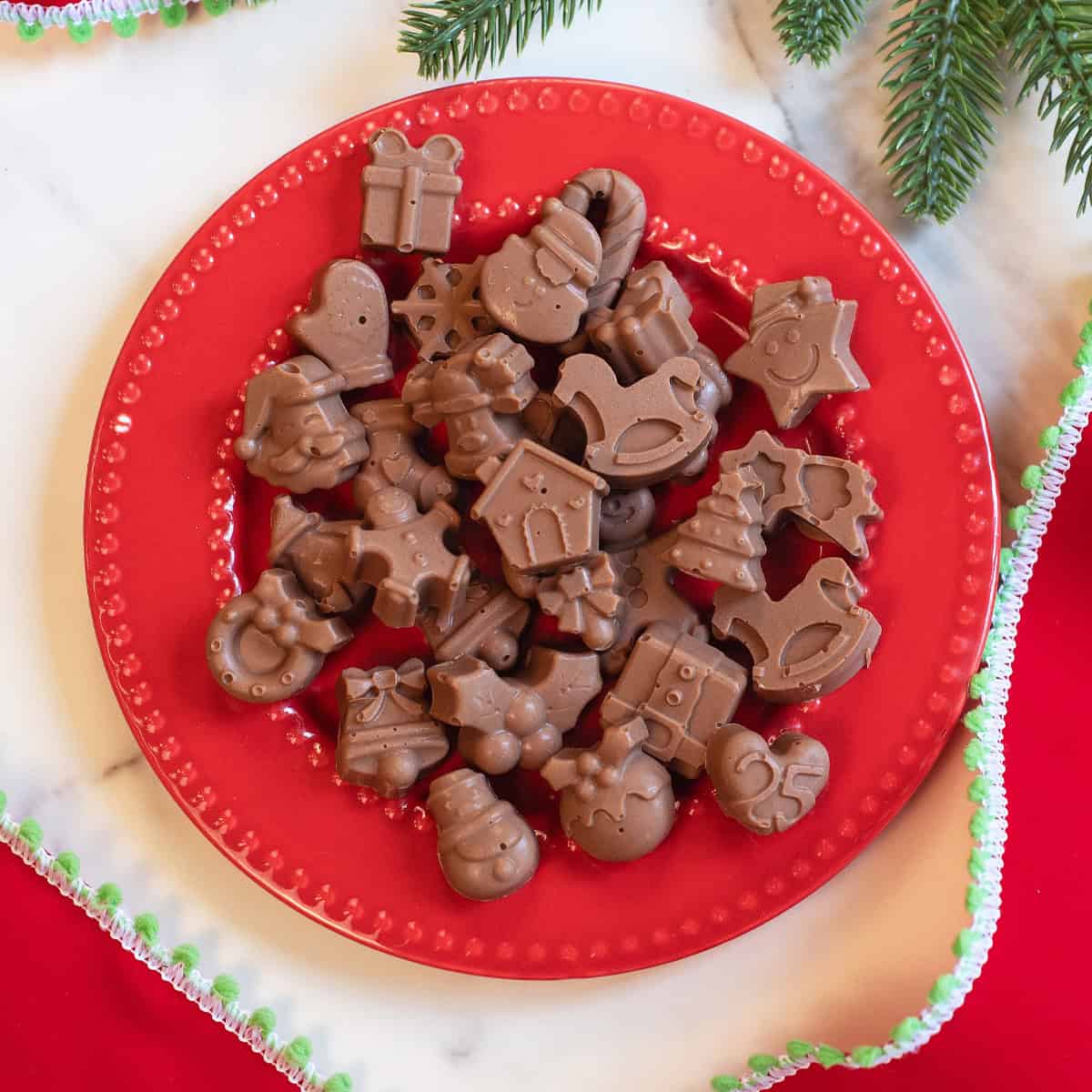 Chocolate Peanut Butter Meltaways on a red plate and festive